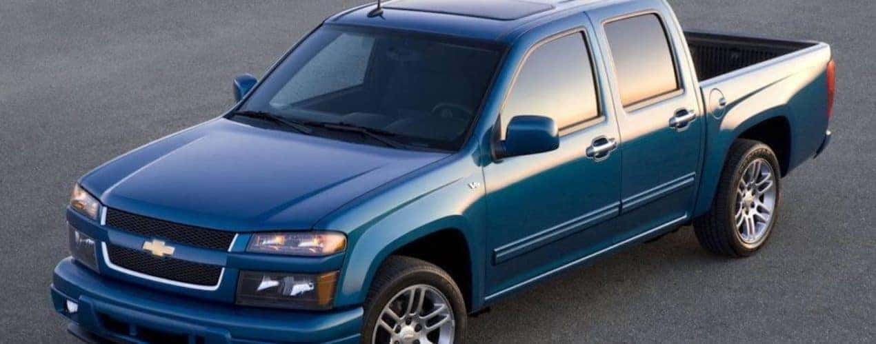A blue 2011 Chevy Colorado is shown from the front at an angle.
