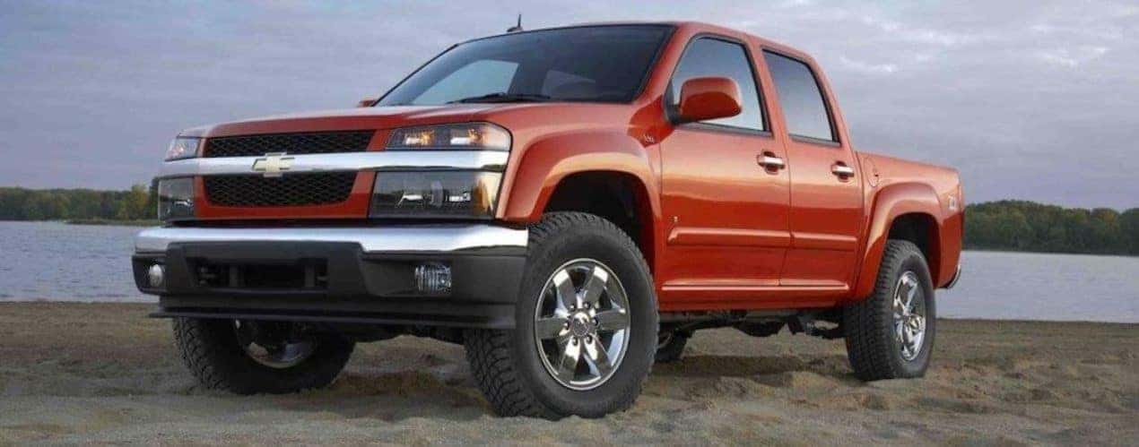 A red 2012 Chevy Colorado is shown from the front at an angle.