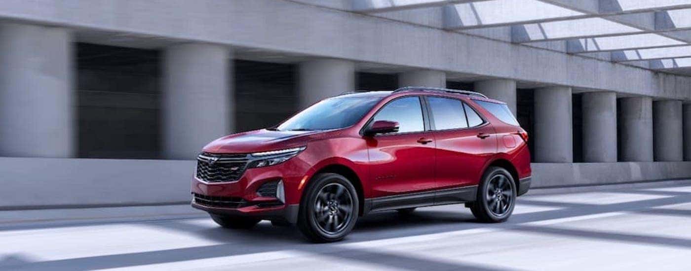 A red 2020 Chevy Equinox RS is shown from the side on the highway.