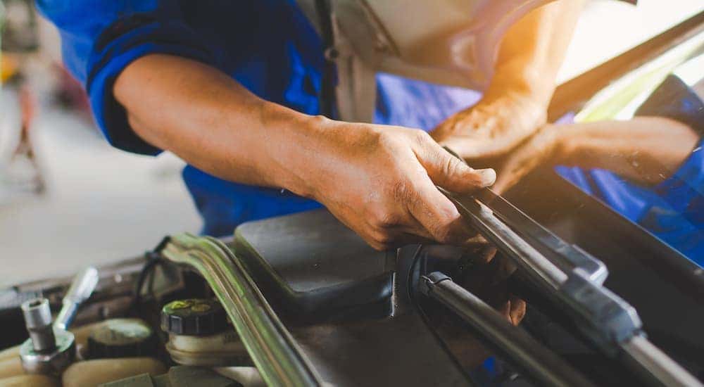 A close up shows a wiper blade being replaced with official GM Parts.