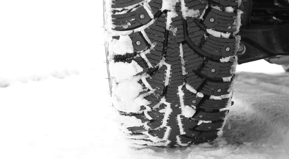 A studded tire is shown in close up.