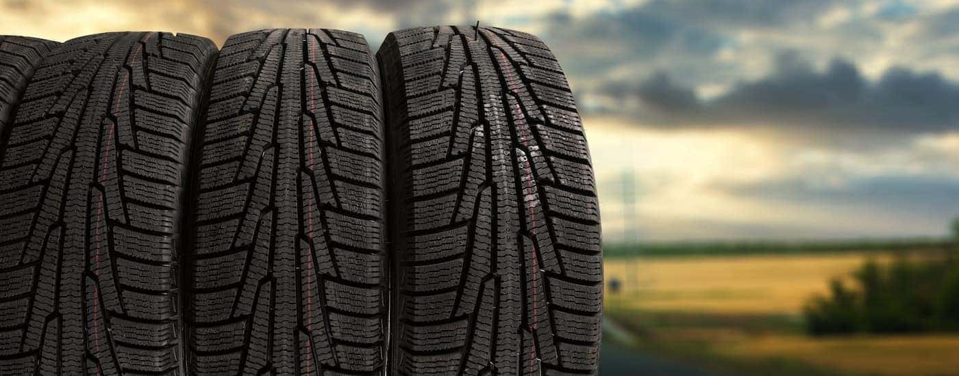 A set of four tires are should at sunset.
