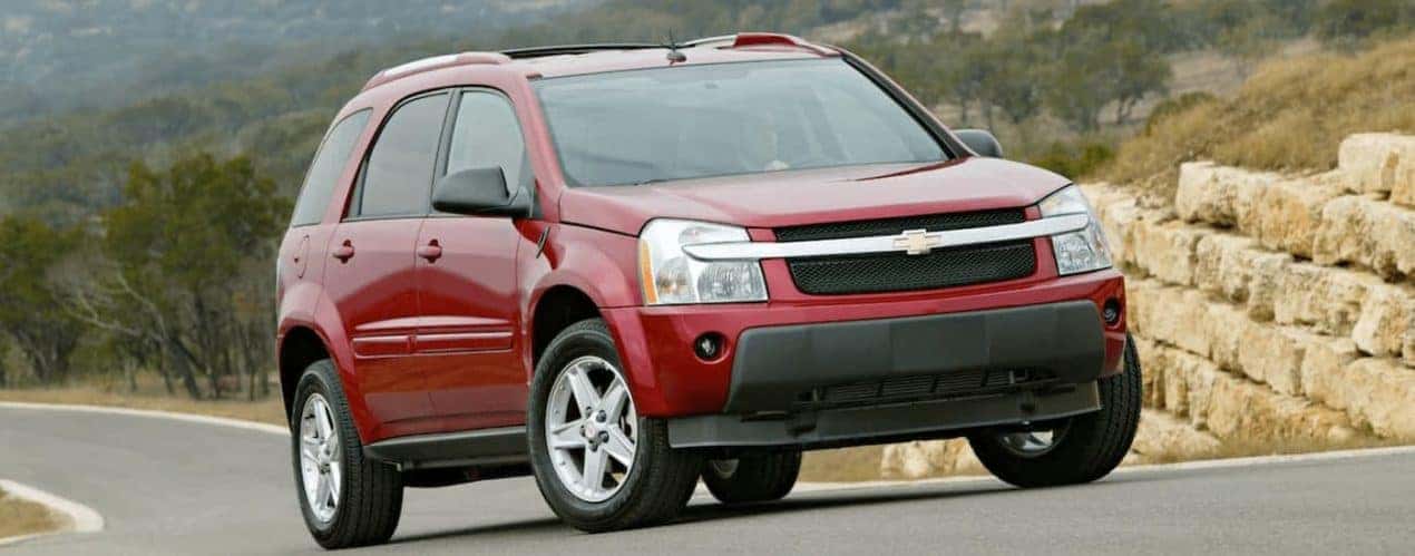 A red 2006 used Chevy Equinox is shown on a road outside Cincinnati, OH.