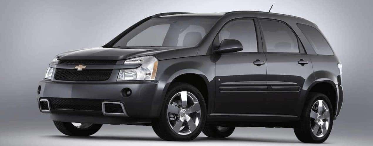 A dark grey 2008 used Chevy Equinox is facing left on a grey background. Check one out a Cincinnati, OH dealership.