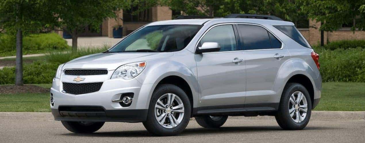 A silver 2010 used Chevy Equinox is parked outside a Cincinnati, OH building.