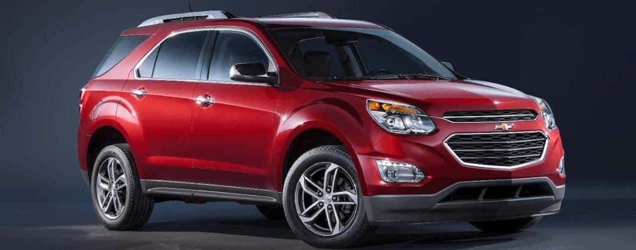 A red 2016 used Chevy Equinox is on a dark background.