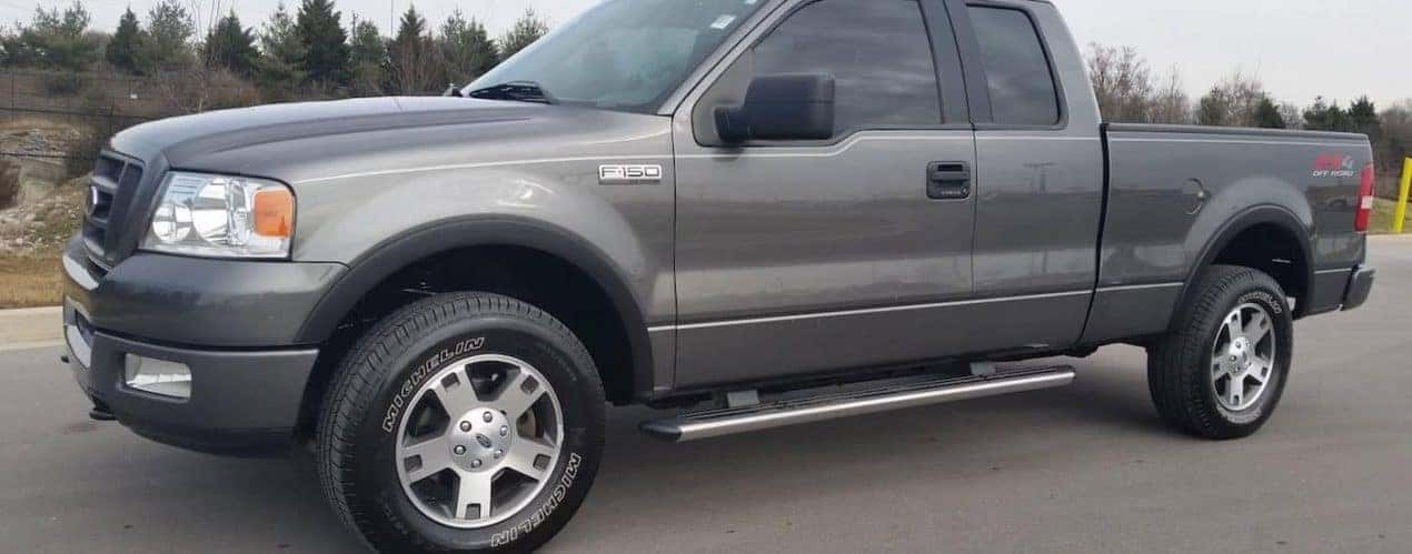 A grey 2005 Ford F-150 11th Generation is shown parked on in an empty lot.
