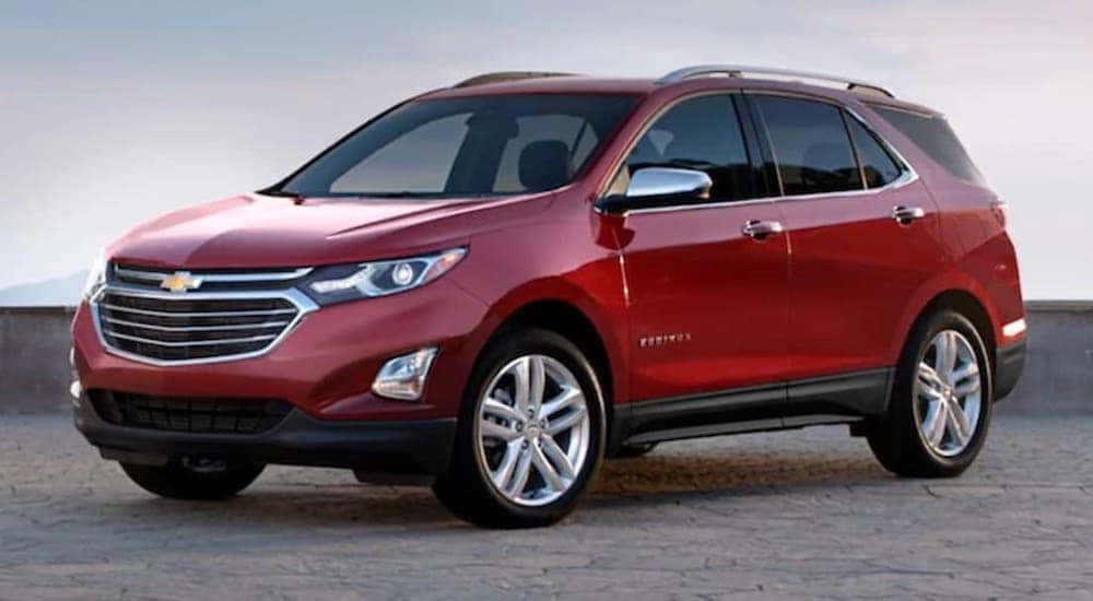 A red 2020 Chevy Equinox is shown from the side.