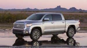 A silver 2017 Toyota Tundra is shown parked on an empty paved lot.