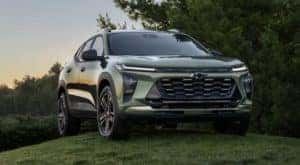 A green 2024 Chevy Trax parked on a grass hill.