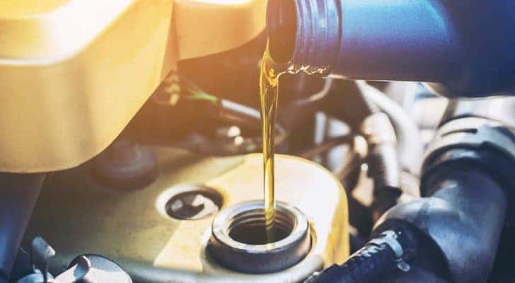Oil is shown flowing into a tank.