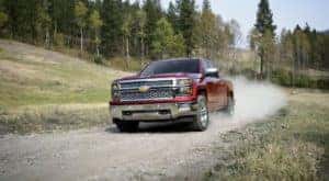 A red 2014 Chevy Silverado 1500 LTZ is shown on a trail after leaving a used Chevrolet dealer.
