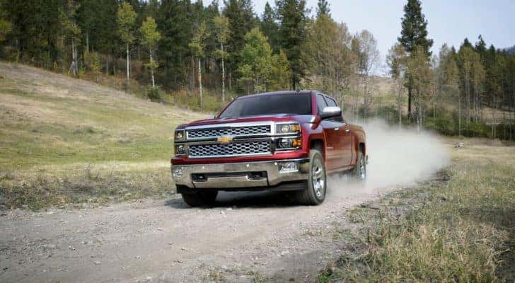 A red 2014 Chevy Silverado 1500 LTZ is shown on a trail after leaving a used Chevrolet dealer.