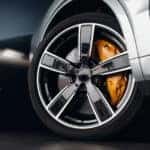 A performance tire is shown on a silver car.