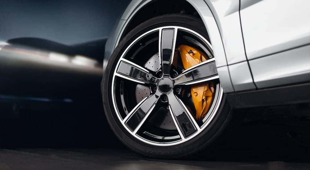 A performance tire is shown on a silver car.