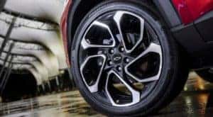 A close up shows the rim on a red 2024 Chevy Trax RS.