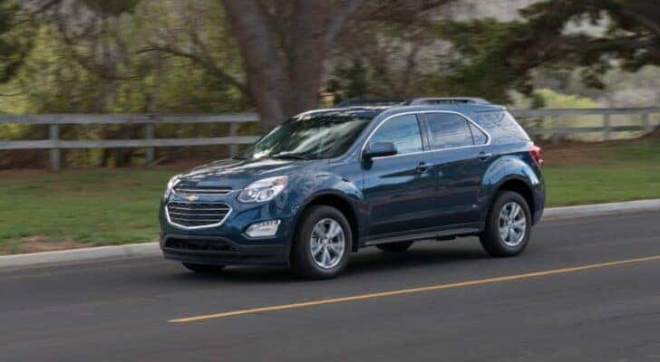 A blue 2016 Chevy Equinox is shown from the front at an angle after leaving a dealer that has Cheap used cars in Cincinnati.