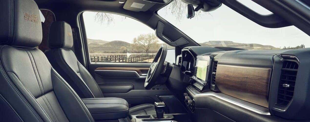 The black and brown interior of a 2024 Chevy Silverado 1500 High Country is shown during a 2024 Chevy Silverado 1500 vs 2024 Ford F-150 comparison.