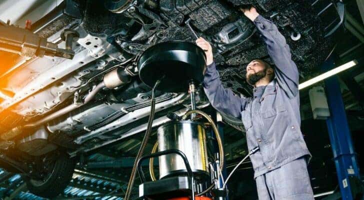 A mechanic is shown performing an oil change near Mason.