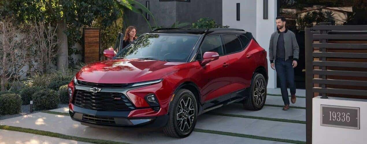 A red 2024 Chevy Blazer is shown parked on a driveway after participating in a 2024 Chevy Blazer vs 2024 Nissan Murano comparison.