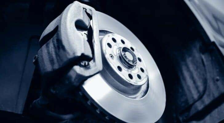 A close-up of a brake assembly is shown while performing a brake service near Monroe.