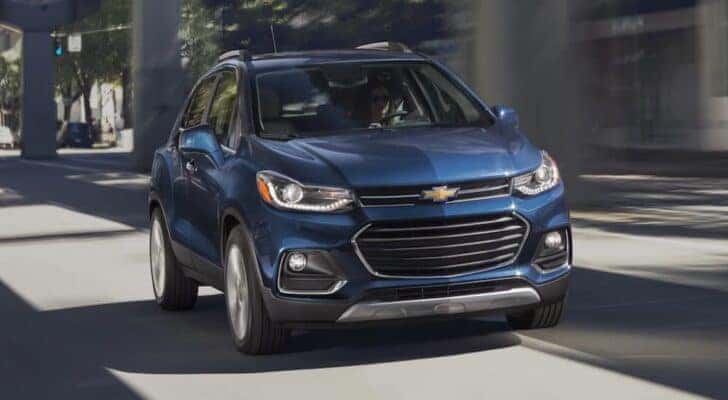 A blue 2020 Chevy Trax is shown driving to view used SUVs for sale in Cincinnati.