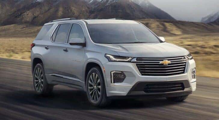 A silver 2022 Chevy Traverse is shown driving after viewing used SUVs for sale near Montgomery.