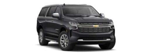 A black 2024 Chevy Suburban Premier angled right.