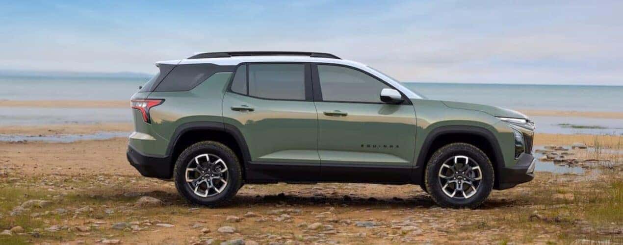 A green 2025 Chevy Equinox is shown parked near water.