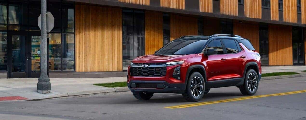 A red 2025 Chevy Equinox RS is shown stopped near a stop sign.