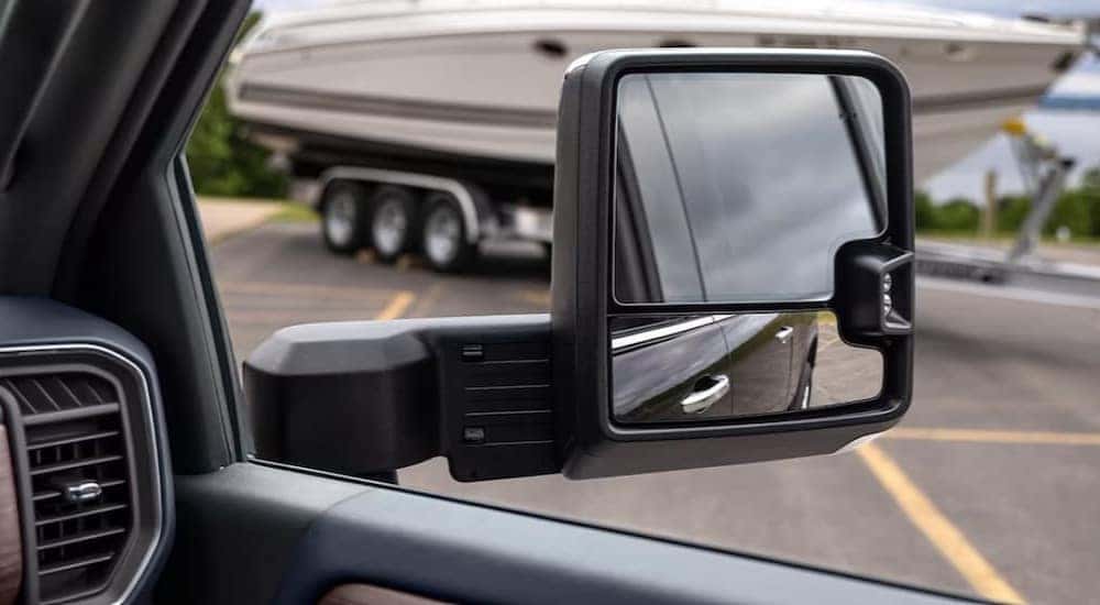 A close-up of a side view mirror on a 2024 Chevy Silverado 2500 HD is shown.