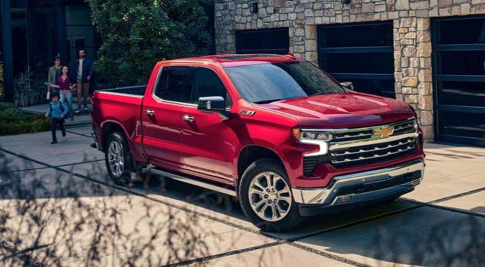 A red 2024 Chevy Silverado 1500 Z71 parked in a driveway.