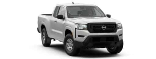 A white 2024 Nissan Frontier is angled right.