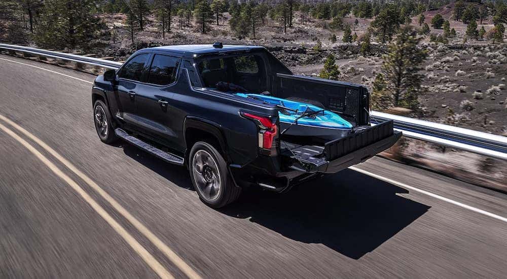 Overhead view of a black 2024 Chevy Silverado EV with a kayak in the truck bed.
