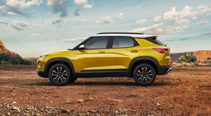 A yellow 2023 Chevy Trailblazer ACTIV is shown parked off-road.