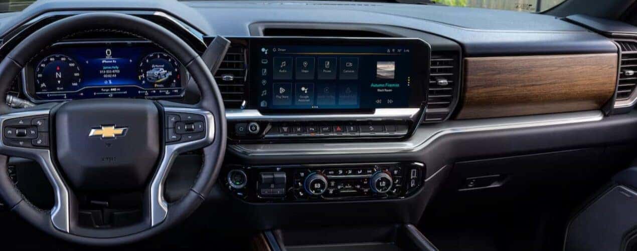 The black and brown interior and dash in a 2025 Chevy Silverado 2500 HD is shown.