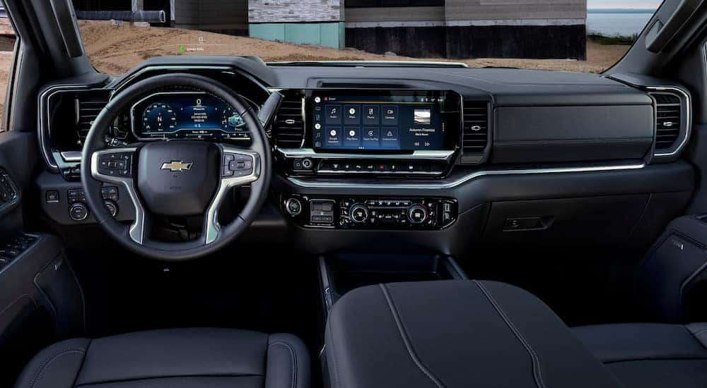 The black interior of a 2025 Chevy Silverado 3500 HD is shown from the driver's seat.