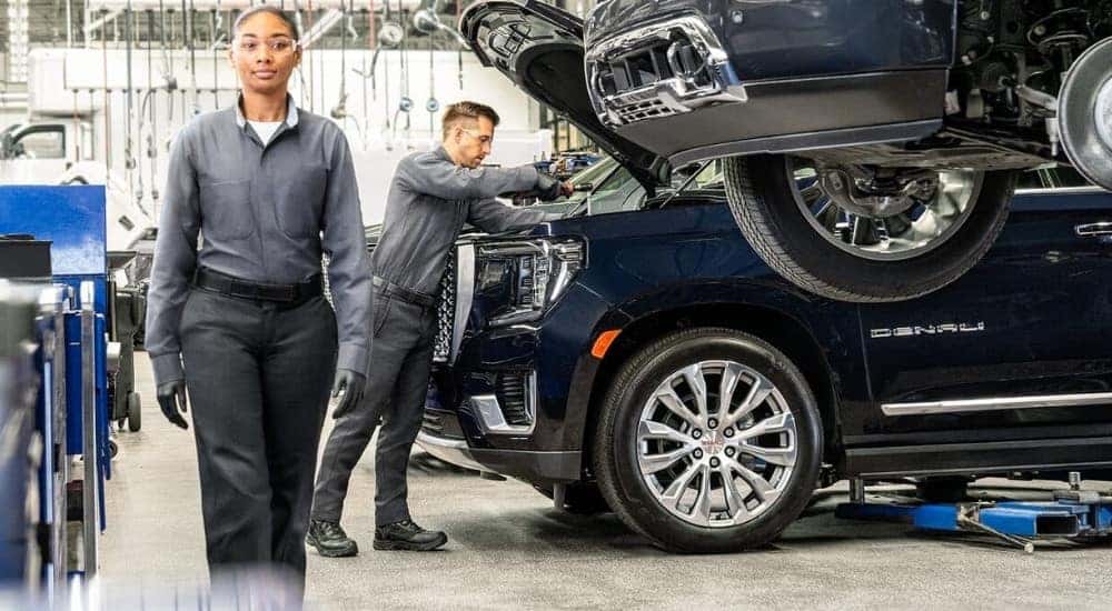 A technician is shown working on a 2021 GMC Yukon Denali at a GMC service center in Cincinnati.