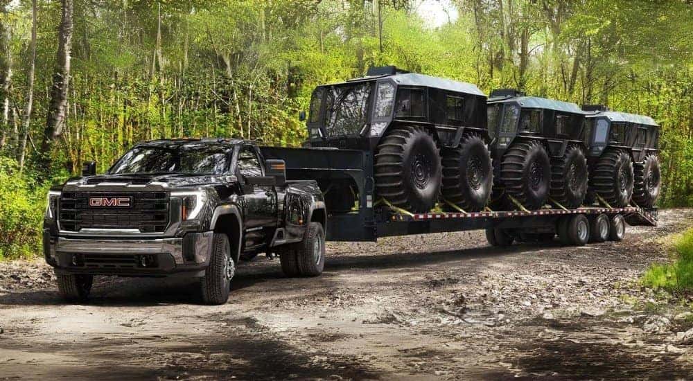 A black 2025 GMC Sierra 3500HD is shown towing SHERPs.