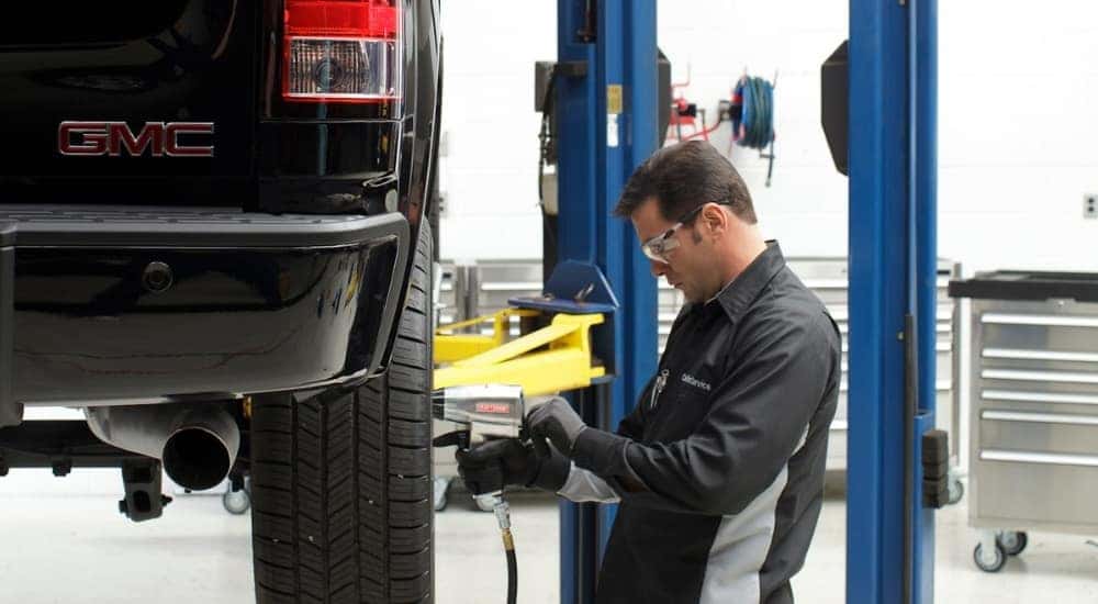 A technician is shown doing a tire rotation.