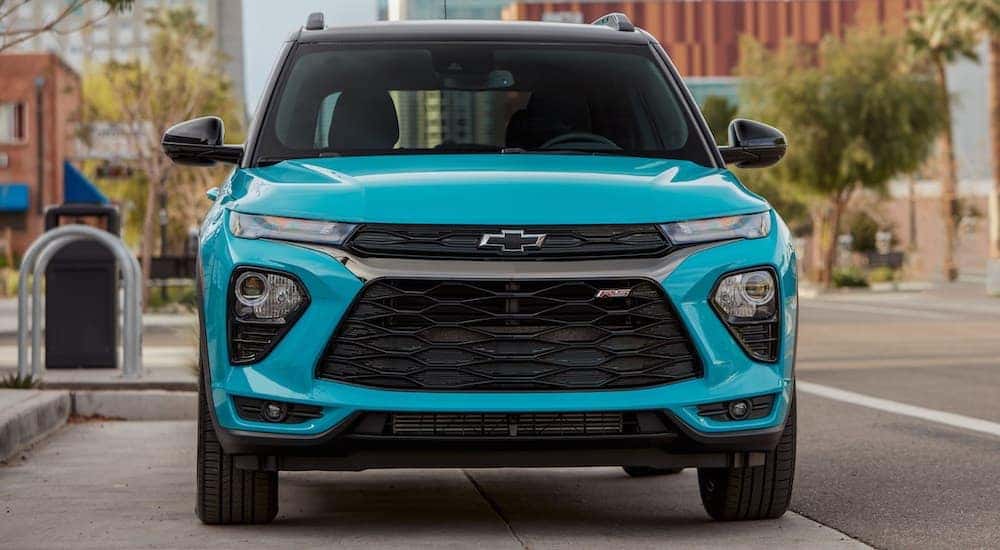 Head-on view of a teal 2021 used Chevy Silverado for sale.
