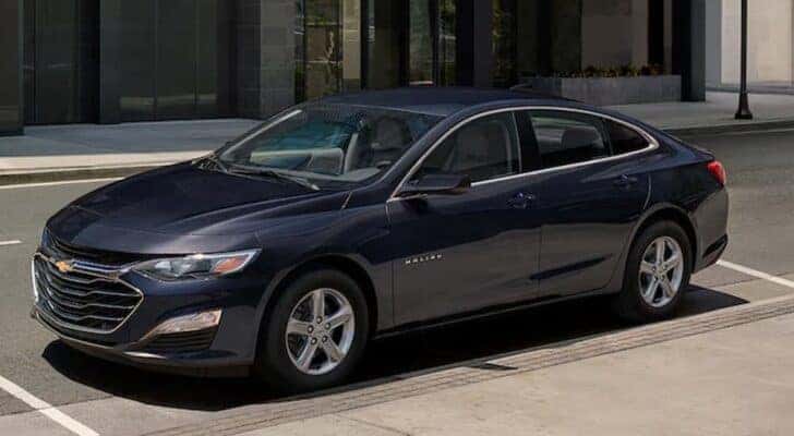 A blue 2023 Chevy Malibu is shown parked after viewing a used Chevy Malibu for sale.