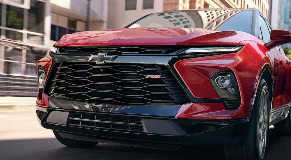A close-up on the grille of a red 2025 Chevy Blazer RS.
