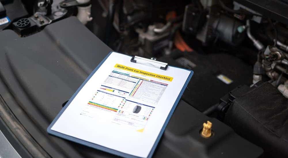 A multipoint inspection sheet is shown on a clipboard.