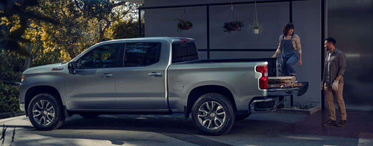 A silver 2025 Chevy Silverado 1500 Z71 is shown parked on a driveway.