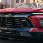 Close-up on the grille of a red 2025 Chevy Blazer RS.