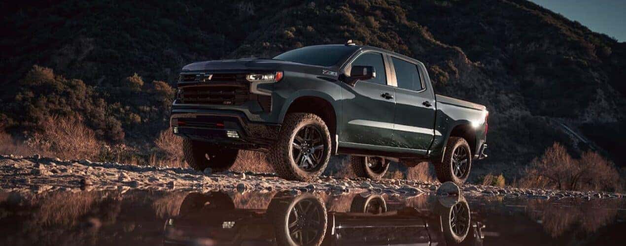 A green 2025 Chevy Silverado 1500 Z71 is shown parked off-road.