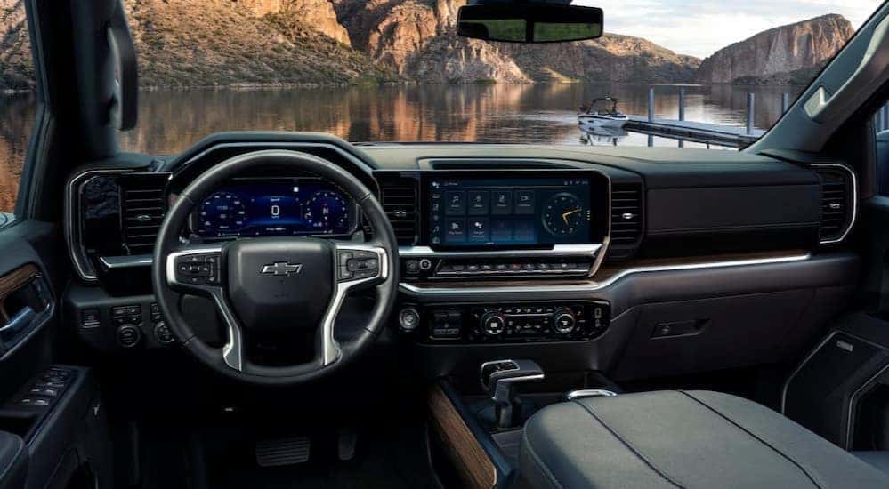 The black interior and dash are shown in a 2025 Chevy Silverado 1500.