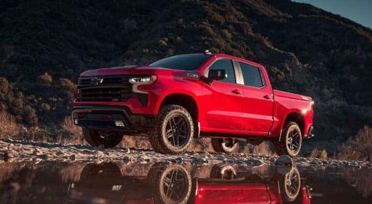 A red 2023 Chevy Silverado Z71 Trail Boss is shown from the front at an angle.