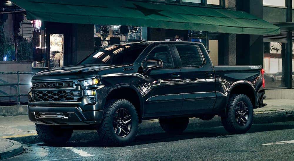 A black 2025 Chevy Silverado 1500 Z71 Trail Boss Midnight Edition is shown from the side.